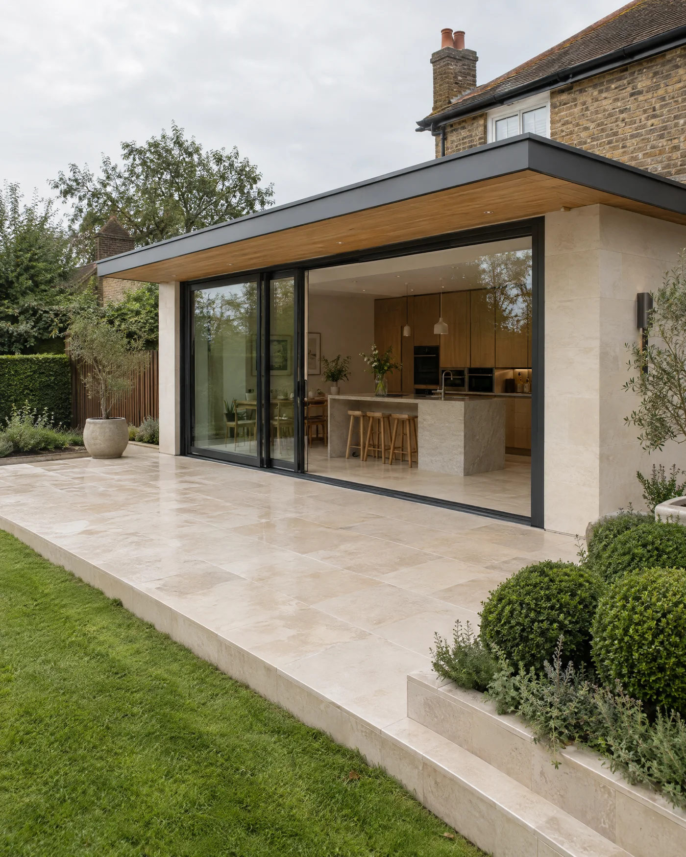 Completed contemporary home extension with natural stone, oak and garden-facing glazing